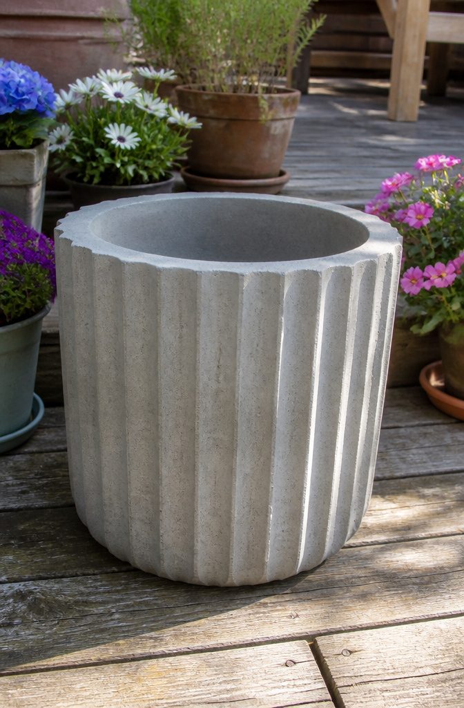 DIY Large Planters Outdoor Cheap: 10 Ideas for 2026 2 Fluted cement planter with vertical ridges and colorful flowering plants.