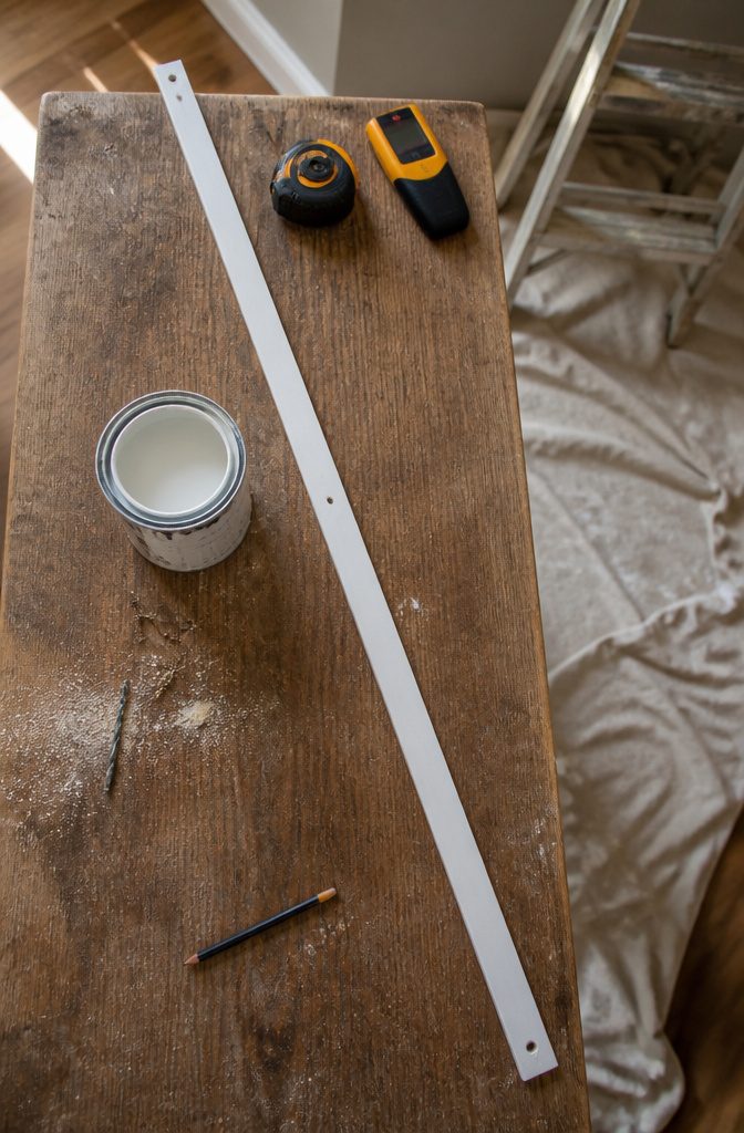Flat moulding strip prepared for mounting across ceiling joists
