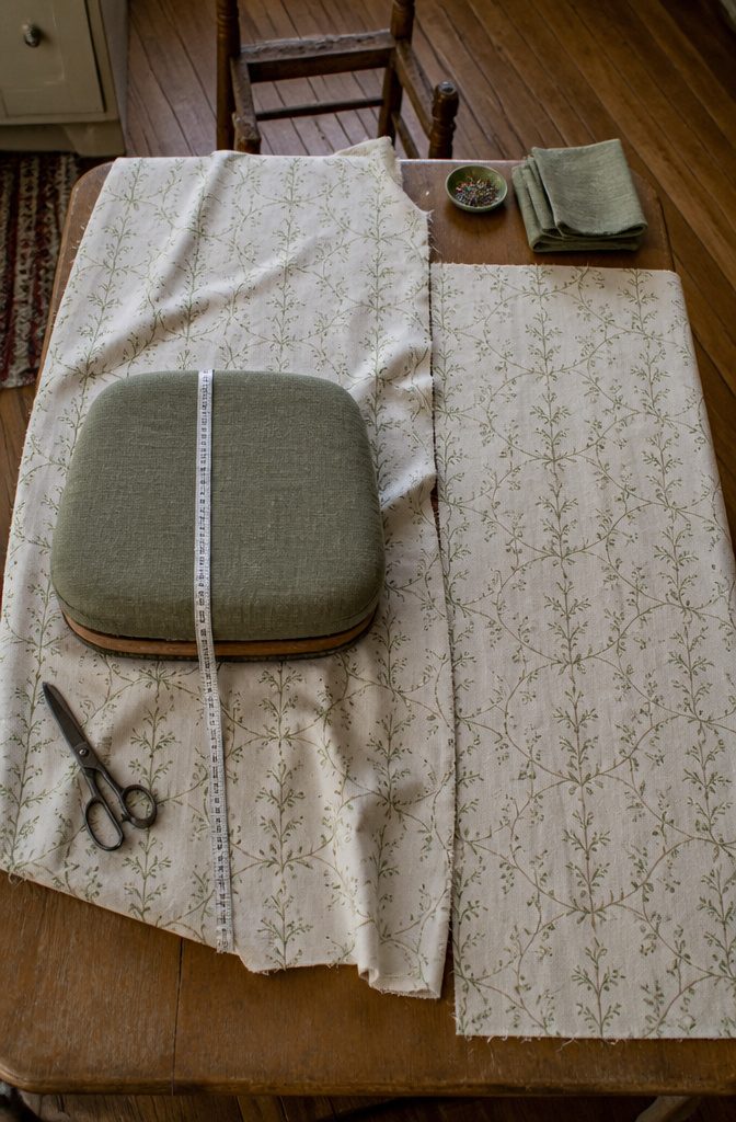 How to Reupholster Kitchen Chairs in 8 Steps 5 Upholstery fabric laid out for cutting around a chair seat