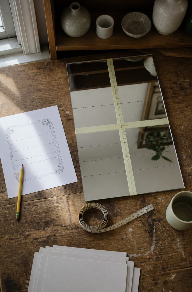 How to Write on Mirrors: 6 Steps for Clean, Readable Text 4 Mirror lettering sketch beside measuring tape and ruler on a table